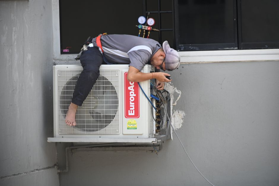 Professional HVAC technician working on a modern climate control system